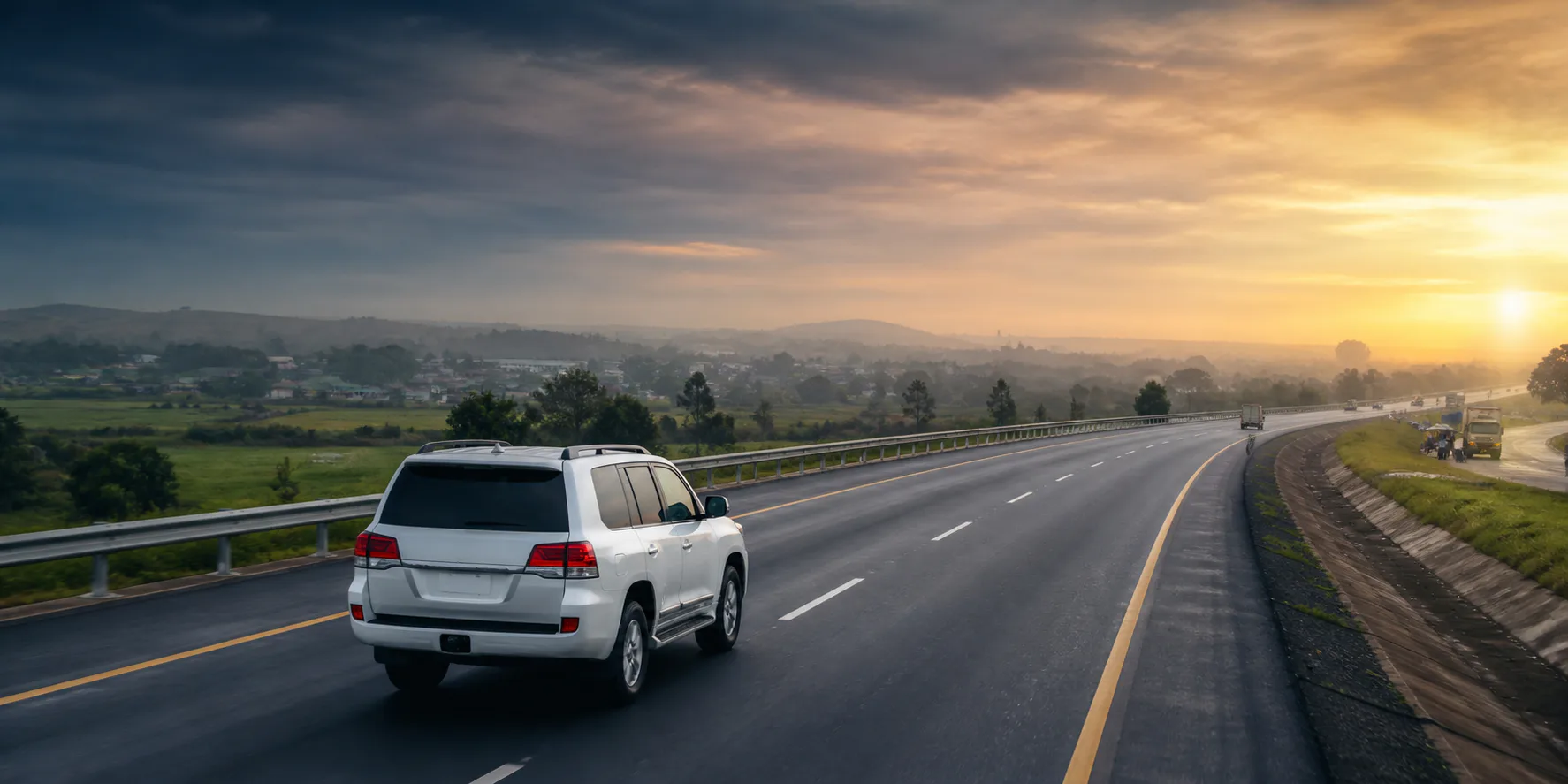 Utility vehicle travelling on an intercity Nigerian highway at dawn